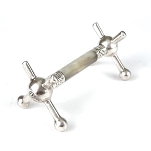 May include: Silver and white decorative stand with a four-pronged base and a four-pronged top. The stand has a white, textured, cylindrical center.