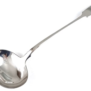 May include: A silver ladle with a long handle and a rounded bowl. The handle has a decorative design at the end and is engraved with the year "1811".