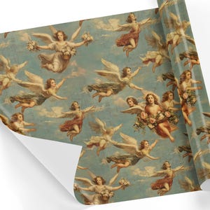 Angels Cherubim Antique Gift Wrap shown rolled out, featuring a classic design of angelic figures and cherubs in a celestial scene with flowers and clouds, ideal for elegant gift presentations.