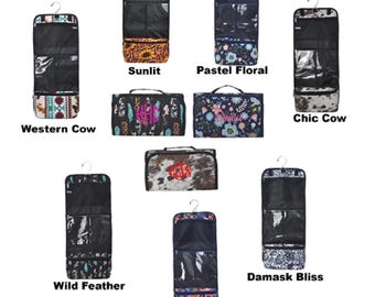 May include: Nine hanging travel makeup bags with different patterns. The patterns include: Western Cow, Sunlit, Pastel Floral, Chic Cow, Wild Feather, Damask Bliss, Paisley Whirl.