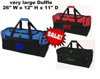 May include: Three large duffel bags in black, blue, and red. The blue bag has a monogram, the red bag has "MTR", and the black bag has "Alexa". The bags are 26 inches wide, 12 inches high, and 11 inches deep.
