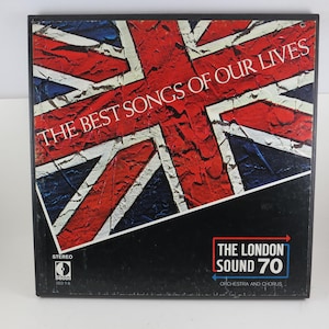 May include: A vintage vinyl record album titled "The Best Songs of Our Lives." The album cover features a distressed Union Jack flag design in red, white, and blue. The album is from "The London Sound 70" orchestra and chorus.