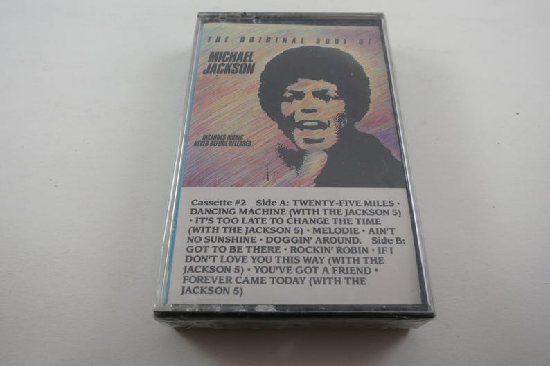 May include: A vintage cassette tape featuring Michael Jackson's album, "The Original Soul of Michael Jackson." The cover has a portrait of Jackson. The tracklist includes songs like "Dancing Machine" and "Rockin' Robin."