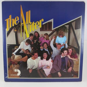 May include: Vintage vinyl record album cover for "The All Niter" featuring a group of people. The album cover has a blue background with yellow text. The album cover has a vintage aesthetic.