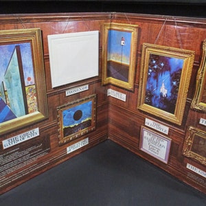 May include: A vintage vinyl record album cover featuring a series of framed paintings with titles like "The Great Gates of Kiev", "Promenade", "The Hut on Fowl Legs", "The Old Castle", "The Sage", and "The Gnome". The album is titled "Pictures at an Exhibition" by Modest Mussorgsky, performed by the London Symphony Orchestra conducted by Andre Previn.