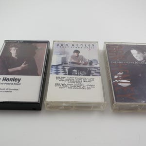 May include: Three cassette tapes with black, white, and clear plastic cases. The tapes are labeled "Don Henley Building The Perfect Beast", "Don Henley The End Of The Innocence", and "The End Of The Innocence".