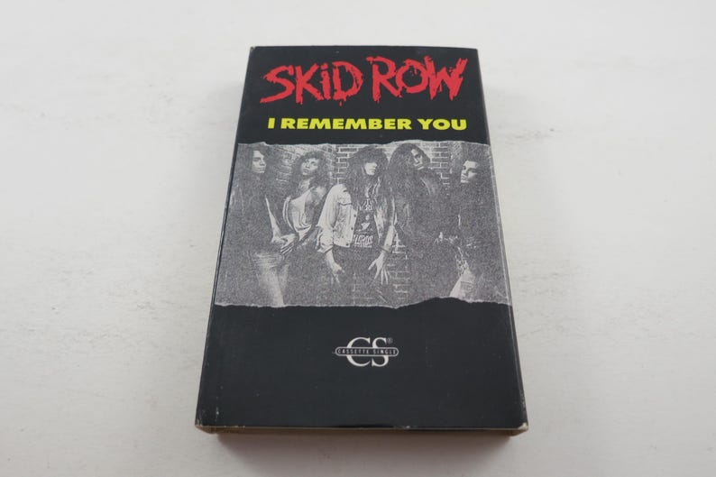 May include: A black cassette tape featuring a band photo of Skid Row. The text on the tape reads "Skid Row" and "I Remember You".