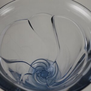 Pu&ograve; includere: Un vaso di vetro trasparente tinto di blu con un design a spirale unico. Il vaso ha una parte superiore ampia e aperta e una forma arrotondata e curva. L'interno presenta un motivo a spirale, creando un aspetto elegante e artistico. Ideale per l'arredamento della casa.