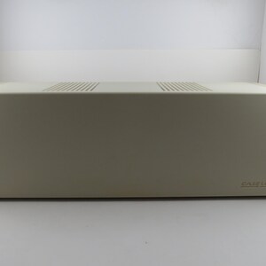 May include: A beige Case Logic media storage box. The box is rectangular with a flat top that has two rows of ventilation slits. The Case Logic logo is on the lower right corner of the box.