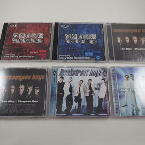 May include: A collection of six Backstreet Boys CDs. The album covers feature images of the band members and album titles. The CDs are in clear plastic cases, with red, blue, and black backgrounds.