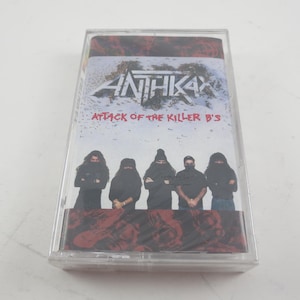 May include: A cassette tape case with a black and white photo of a band called "Anthrax" on the front. The band members are wearing black clothing and the text "Attack of the Killer B's" is printed below the band's name.