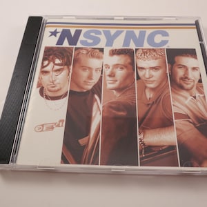 May include: A CD case featuring the boy band *NSYNC. The album cover displays the band's name in blue and a star graphic. The cover art includes individual portraits of the five band members in a vertical layout.