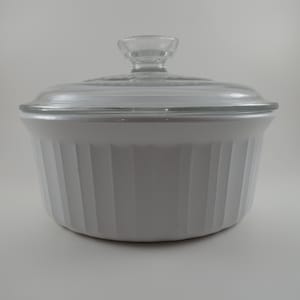 May include: A set of three ceramic mugs with a speckled, cream-colored glaze. Each mug features a different hand-painted floral design in shades of blue, green, and yellow. The mugs have a simple, rounded shape and a comfortable handle.