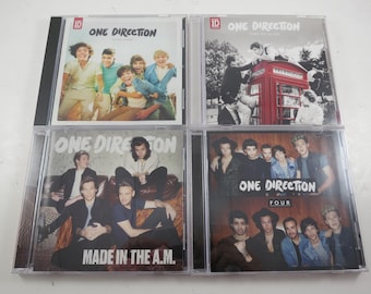 May include: Four CD albums by the band One Direction. The album covers feature images of the band members. The albums are titled "Up All Night", "Take Me Home", "Made in the A.M.", and "Four".