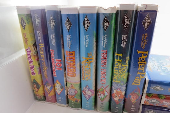 Collection of 11 Vintage Disney Black Diamond VHS Tapes Originals Aladdin Dumbo Bambi Peter Pan Robin Hood and More In Clam Shell Cases