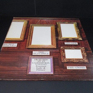 May include: A vintage vinyl record album cover featuring a wood-paneled wall with five ornate gold picture frames. The album title is "Pictures at an Exhibition" by Modest Mussorgsky, Emerson, Lake & Palmer.