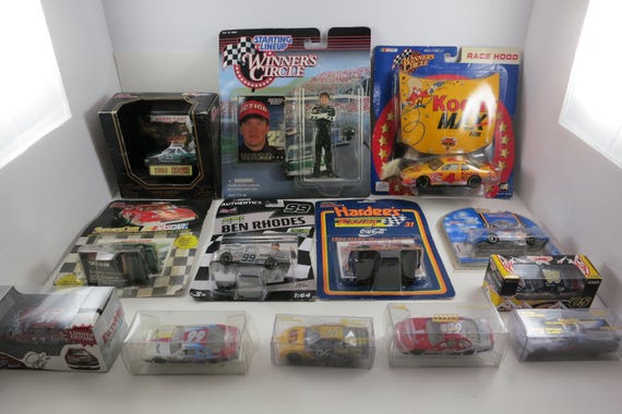 Collection of 13  NASCAR Die Cast Cars 1:64 Scale All New In Packages Including Program Cars Burton Gant Keller Richmond Charlotte