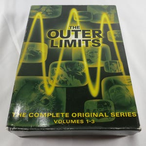 May include: A black box set of The Outer Limits: The Complete Original Series Volumes 1-3. The cover features a yellow graphic wave pattern overlaid on multiple small, green-tinted television screen images showing various scenes and characters.