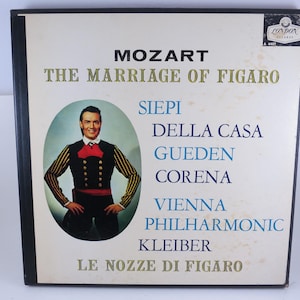 May include: Vintage vinyl record album cover for Mozart's "The Marriage of Figaro." The cover features a portrait of a man in a black and gold jacket, red bow tie, and the names of the performers and orchestra.