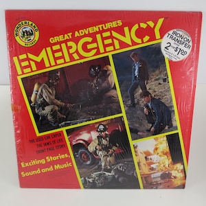 May include: Vintage vinyl record album titled "Emergency" with a red cover. The album features images of firefighters and scenes from the show. The cover includes the text "Great Adventures" and "Exciting Stories, Sound and Music."