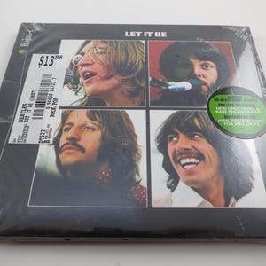 May include: Sealed vinyl record of The Beatles' album "Let It Be." The album cover features four individual portraits of the band members. The album is in a plastic wrap with a price tag and a green sticker.