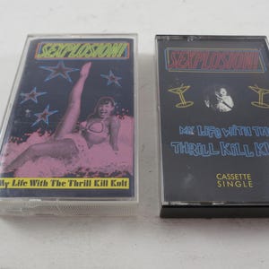 May include: Two vintage cassette tapes. One features a woman in a bikini in pink water with the text "My Life With The Thrill Kill Kult". The other has a black background with the text "My Life With The Thrill Kill Kult" and "Cassette Single".