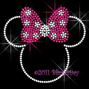 May include: A pink and white rhinestone bow with white rhinestone ears. The design is on a black background. The text "©2011 Bling2Day" is at the bottom of the image.