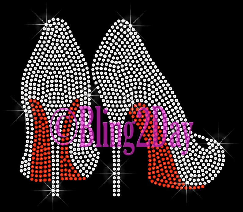 May include: A pair of high-heeled shoes made of white rhinestones with red rhinestone heels. The shoes are outlined in white rhinestones and have a sparkling effect. The text "Bling 2 Day" is written in pink rhinestones.