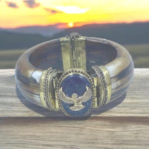 Hinged bracelet features a stunning Maat charm and exquisite Lapis Lazuli stone. #AncientEgyptian #KemeticJewelry #Maat #LapisLazuli #Ma&#39;at
