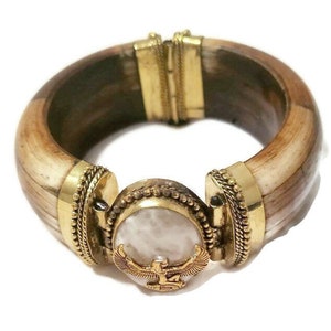 Hinged bracelet featuring a Moonstone and a Maat charm. This is Kemetic jewelry! #EgyptianJewelry #Moonstone #Maat #Ma&#39;at #HingedBracelet