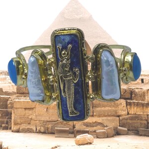 This Ancient Egyptian Isis charm features a Lapis Lazuli stone on a cuff bracelet embellished with 2 white pearls and 2 blue agate stones. image 2