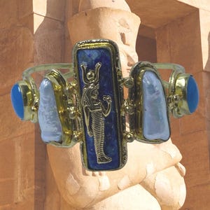 This Ancient Egyptian Isis charm features a Lapis Lazuli stone on a cuff bracelet embellished with 2 white pearls and 2 blue agate stones. image 6
