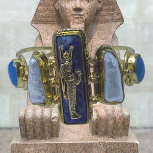 This Ancient Egyptian Isis charm features a Lapis Lazuli stone on a cuff bracelet embellished with 2 white pearls and 2 blue agate stones. image 5