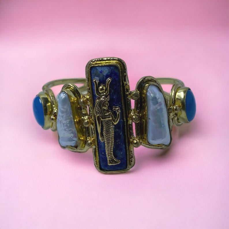 This Ancient Egyptian Isis charm features a Lapis Lazuli stone on a cuff bracelet embellished with 2 white pearls and 2 blue agate stones. image 8