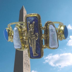This Ancient Egyptian Isis charm features a Lapis Lazuli stone on a cuff bracelet embellished with 2 white pearls and 2 blue agate stones. image 7