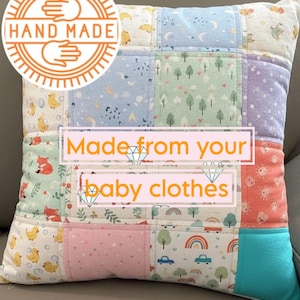 May include: Handmade patchwork pillow made from baby clothes. The square pillow features a variety of colorful fabric squares with patterns of ducks, foxes, trees, rainbows, and cars. The text "Made from your baby clothes" is displayed on the pillow.