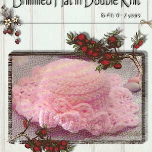 May include: A pink crocheted hat with a wide brim, suitable for babies aged 0-2 years. The hat is displayed on a vintage-style background with floral accents.