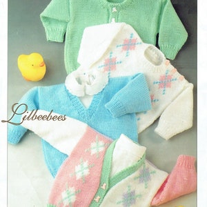 May include: Three knitted baby sweaters in different colors and patterns. The sweaters are white with pink and blue diamond patterns, light blue with a white collar, and green with a white button closure. The sweaters are laid out on a white background with yellow rubber duck toys.