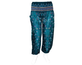 May include: Teal blue harem pants with a peacock feather print. The pants have an elastic waistband with a decorative trim.