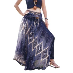 May include: A long, flowing skirt with a black and gold peacock feather print. The skirt has a tie waist and is made of a lightweight fabric.