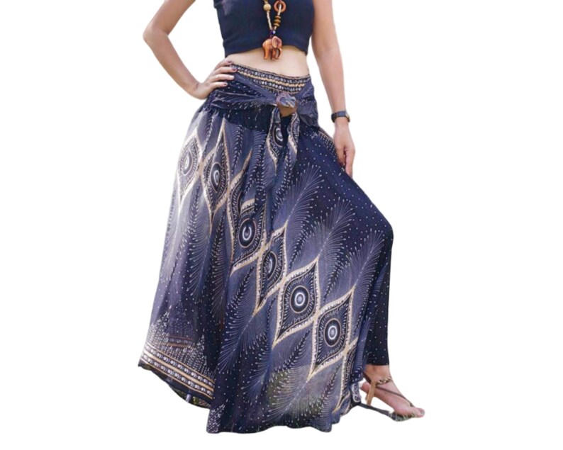 May include: A long, flowing skirt with a black and gold peacock feather print. The skirt has a tie waist and is made of a lightweight fabric.