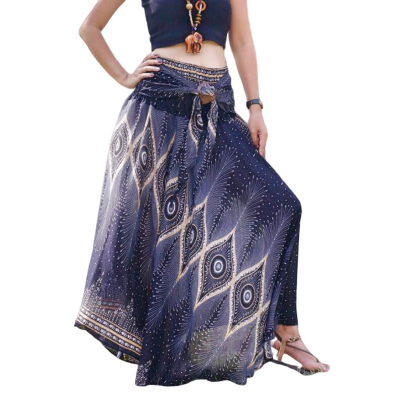 May include: A long, flowing skirt with a peacock feather print in shades of blue, gold, and white. The skirt has a wide waistband with a decorative buckle and a tie at the front.