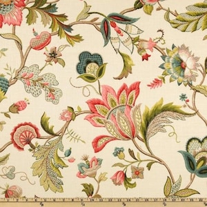 May include: A floral fabric with a white background and a repeating pattern of pink, green, and blue flowers. The flowers are stylized and have a vintage look.