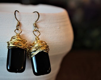 Black rectangular gold wire wrapped drop earrings.