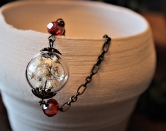 Glass orb anklet with dried flowers and red beads