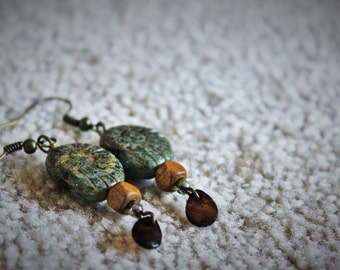 Ammonite style fossil earrings with brown wood beads and red teardrop beads
