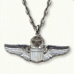 May include: Silver pilot wings necklace with a shield and a star in a wreath.