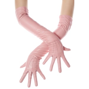 May include: A pair of long pink leather gloves with a decorative stitch detail. The gloves are worn on both hands and are crossed over each other.