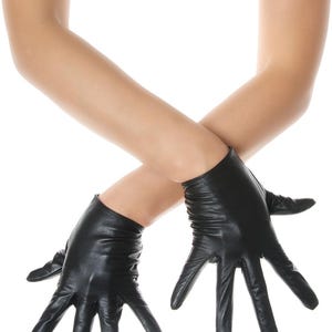 May include: A pair of black leather gloves with a smooth finish and a short wrist length. The gloves feature visible stitching along the fingers and a slightly gathered texture at the wrist area, providing a fitted appearance on the hands.