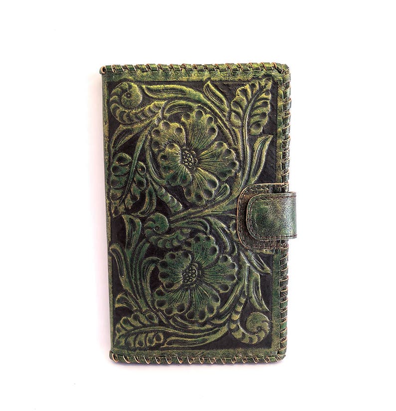 May include: A green leather wallet with a floral embossed design. The wallet has a flap closure with a snap button.